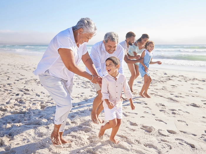 A group of adults and children playing on the beach