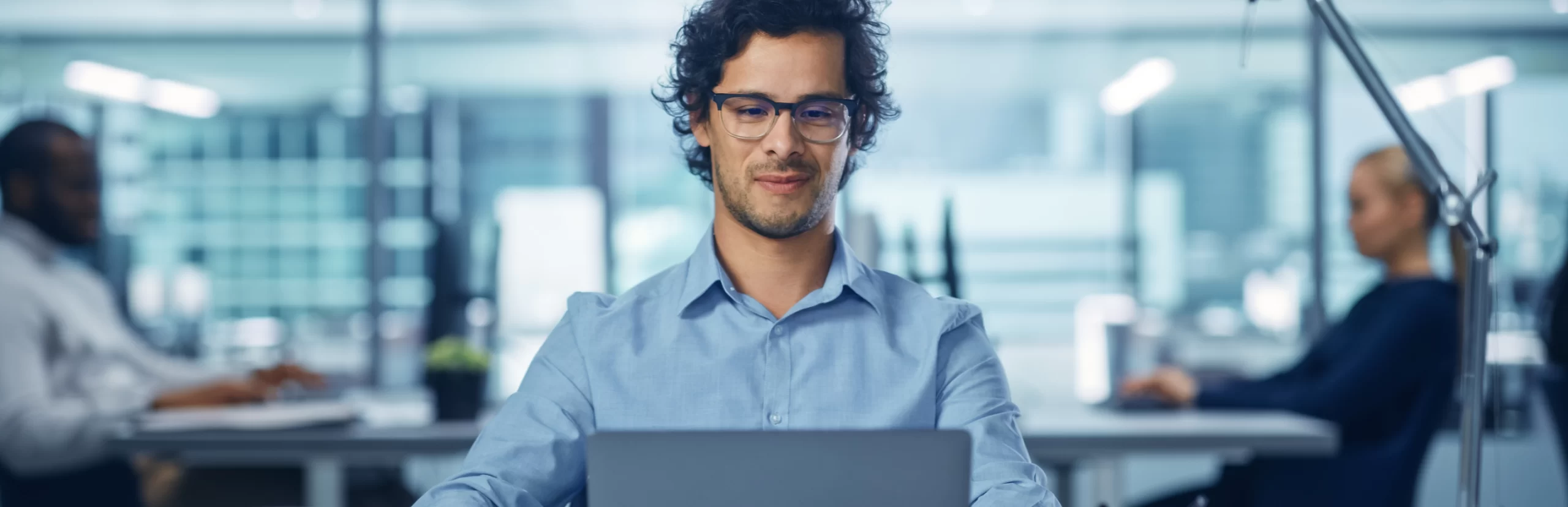 A man sitting at a table with a laptop in front of him