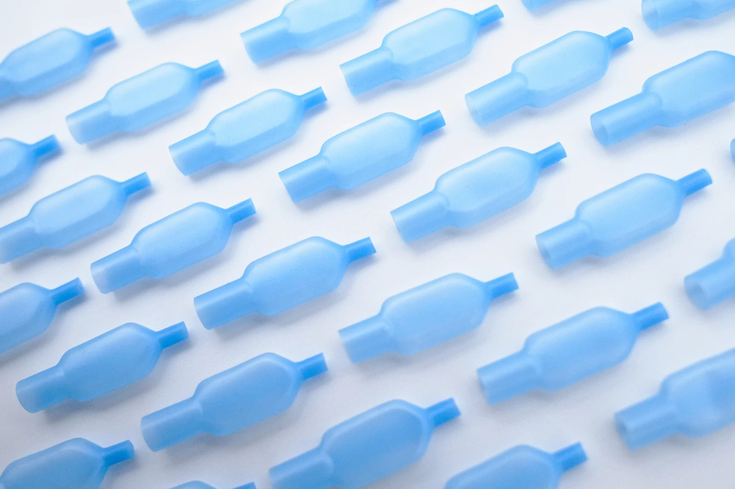 A group of blue plastic bottles sitting on top of a table